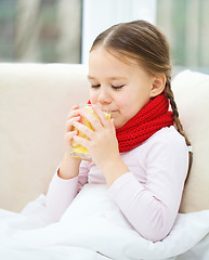 Image showing Ill little girl is drinking vitamin cocktail