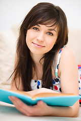 Image showing Woman is reading a book