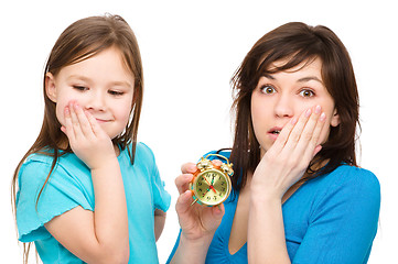 Image showing Little girl and her mother are anxious about time