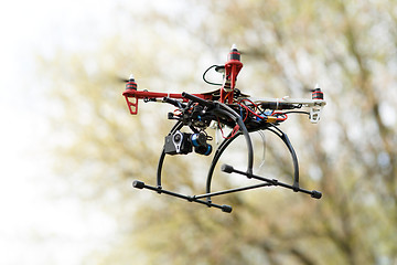 Image showing Quadrocopter while flying in the forest. 