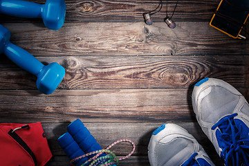 Image showing Sport stuff on wooden table, top view