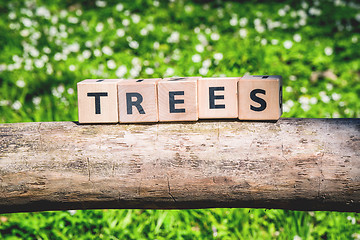 Image showing Tree log with a wooden sign