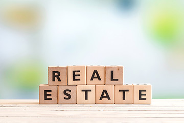 Image showing Real estate sign on a wooden table