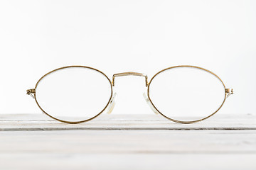 Image showing Eyeglasses on a wooden desk