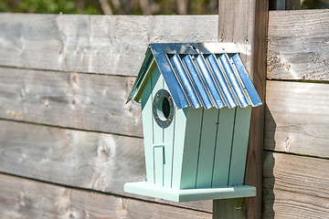 Image showing Cute birdhouse hanging on a fence