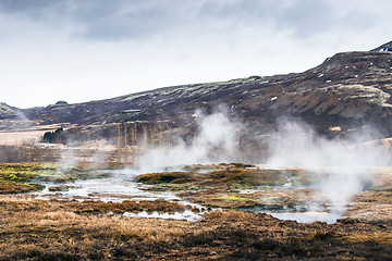 Image showing Misty swamp beneath a mountain