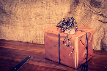 Image showing Shiny Christmas present on a wooden desk