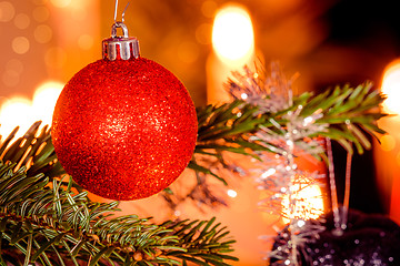 Image showing Red Christmas bauble and shiny lights