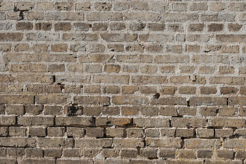 Image showing Old brick wall with worn stones