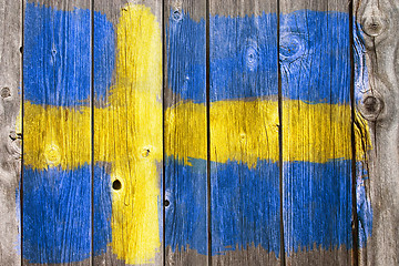 Image showing swedish colors on old wooden wound