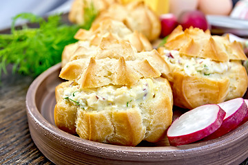 Image showing Appetizer of radish and cheese in profiteroles on clay plate wit