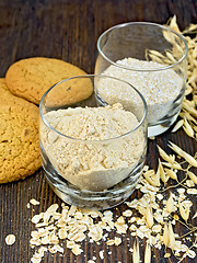 Image showing Flour and bran oat in glass with cookies on board