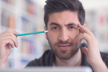 Image showing student in school library using laptop for research