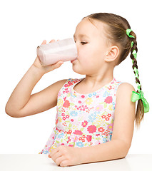 Image showing Cute little girl with a glass of milk