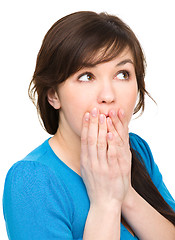 Image showing Woman is covering her mouth in astonishment