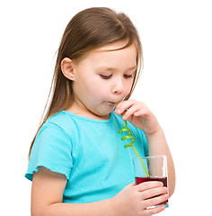 Image showing Little girl is drinking cherry juice