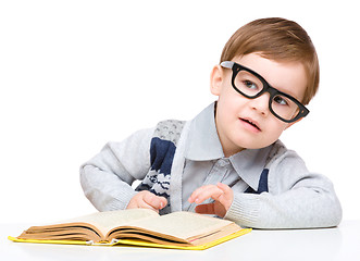 Image showing Little child play with book