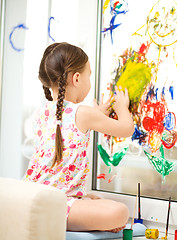 Image showing Portrait of a cute girl playing with paints