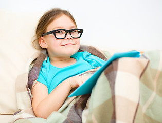 Image showing Little girl is reading a book