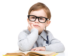 Image showing Little child play with book