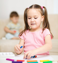 Image showing Little girl is playing with plasticine