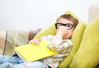 Image showing Little boy is reading book