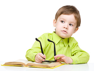 Image showing Little child play with book