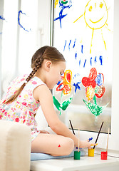 Image showing Portrait of a cute girl playing with paints