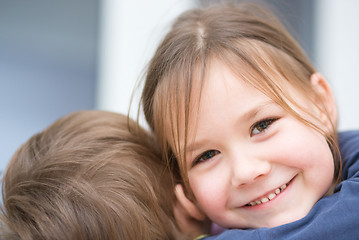 Image showing Little girl is embracing her brother