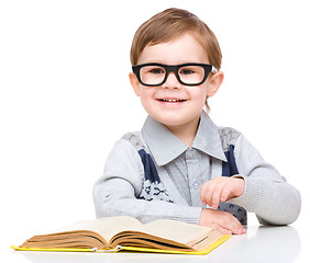 Image showing Little child play with book