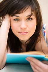 Image showing Woman is reading a book