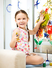 Image showing Portrait of a cute girl playing with paints