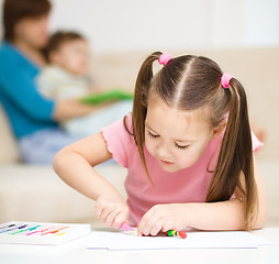 Image showing Little girl is playing with plasticine