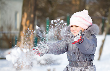 Image showing Little girl is throwing snow