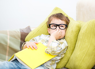 Image showing Little boy is reading book