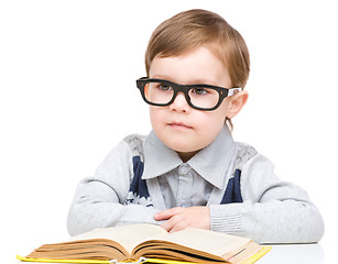 Image showing Little child play with book