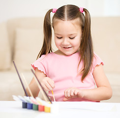 Image showing Cute cheerful child play with paints