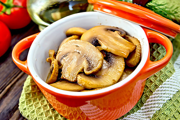 Image showing Champignons fried in roaster on dark board