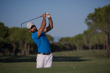 Image showing pro golfer hitting a sand bunker shot