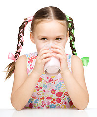 Image showing Cute little girl with a glass of milk