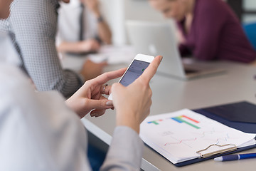 Image showing close up of  busineswoman hands  using smart phone on meeting