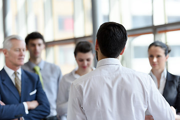 Image showing young startup businessman making presentation to senior investio