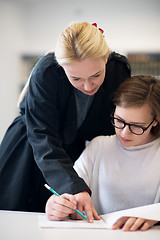 Image showing female teacher helping students on class