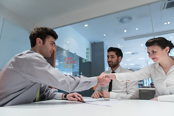 Image showing young couple signing contract documents on partners back