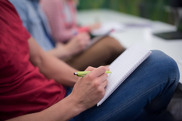 Image showing male student taking notes in classroom