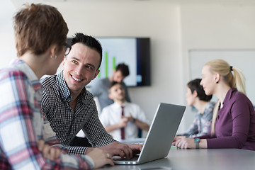 Image showing young business couple working on laptop, businesspeople group on