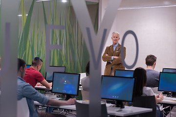 Image showing teacher and students in computer lab classroom