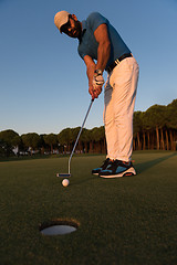 Image showing golfer  hitting shot at golf course