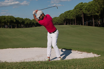 Image showing golfer hitting a sand bunker shot