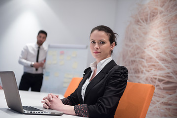 Image showing young business woman on meeting  using laptop computer